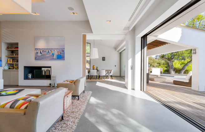 luxury living room with fireplace, terrace, and sea view